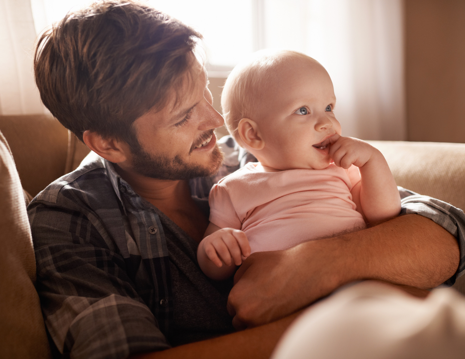 Cropped shot of an adoring father holding his baby on his lap