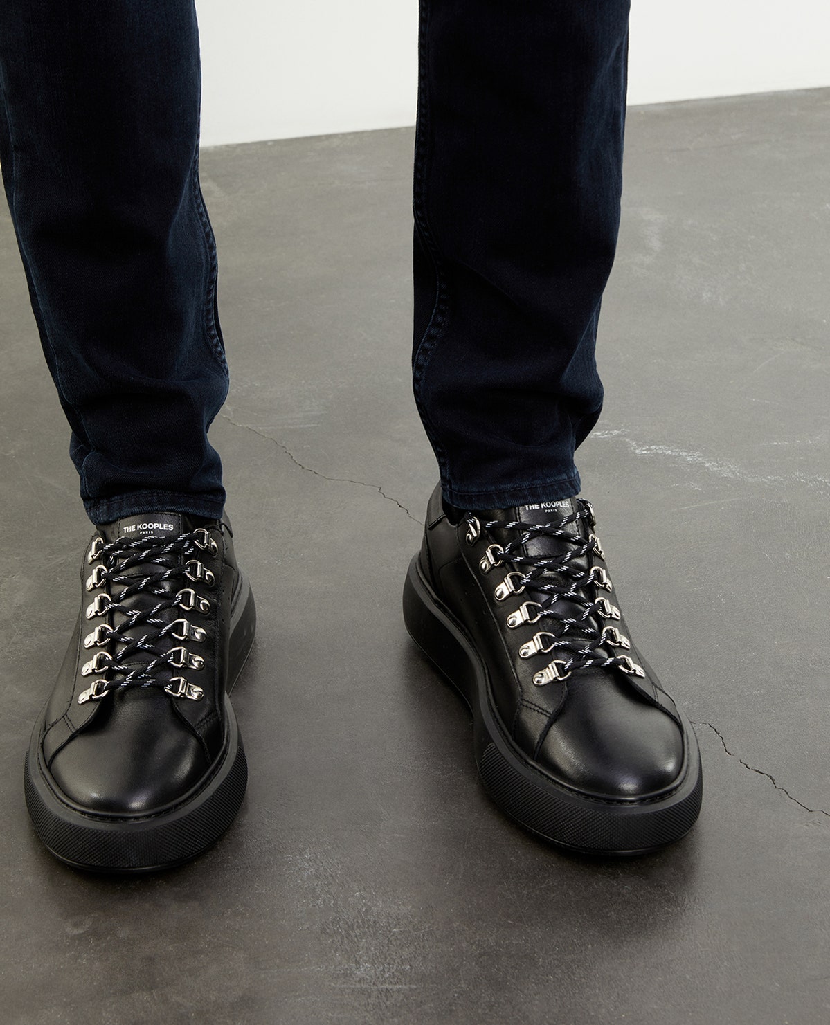 The KOOPLES WEDGE BLACK SNEAKERS IN LEATHER WITH EYELETS